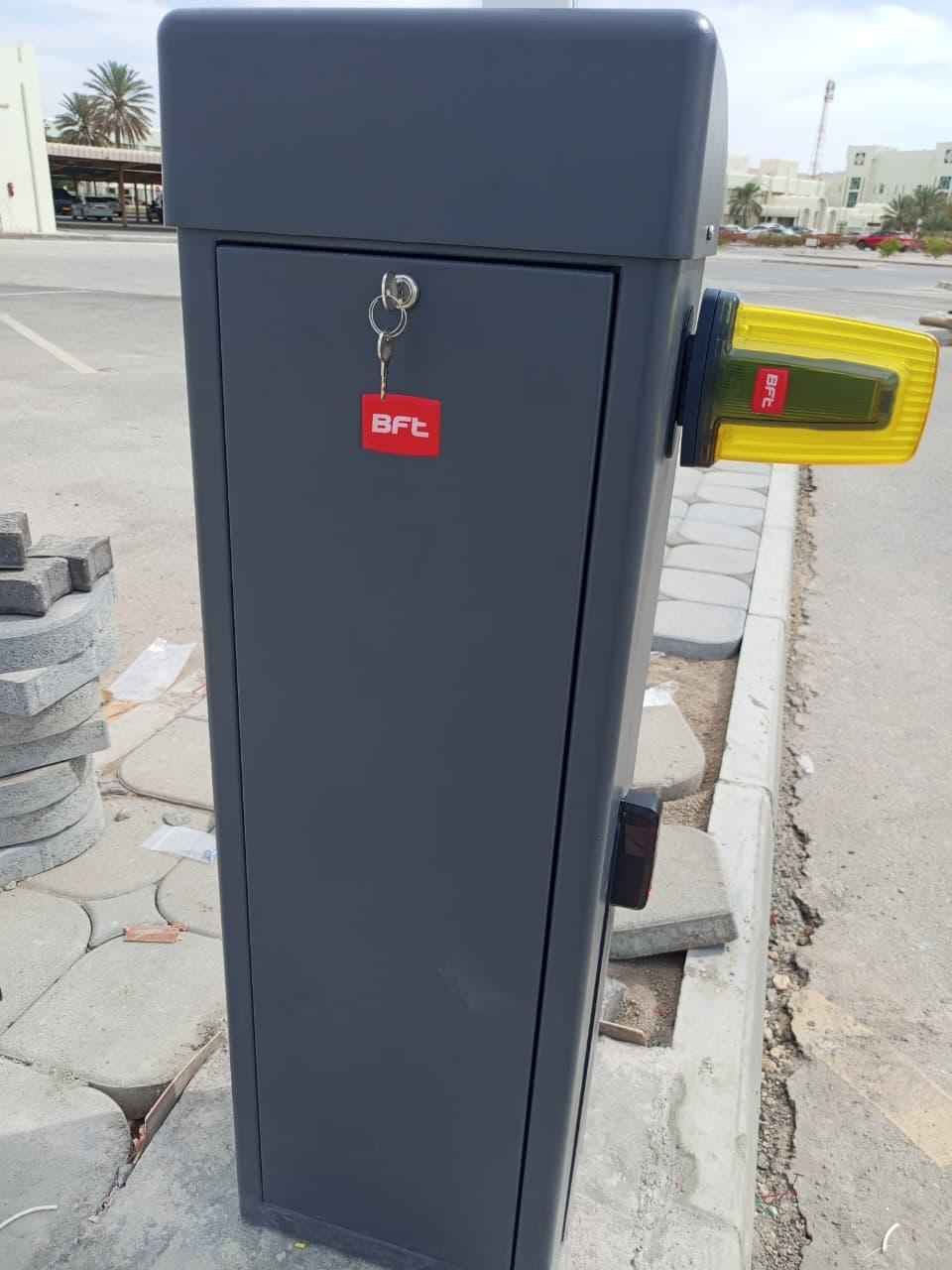 BFT boom barrier fitted with an amber beacon and photocell, ready for commissioning in Oman