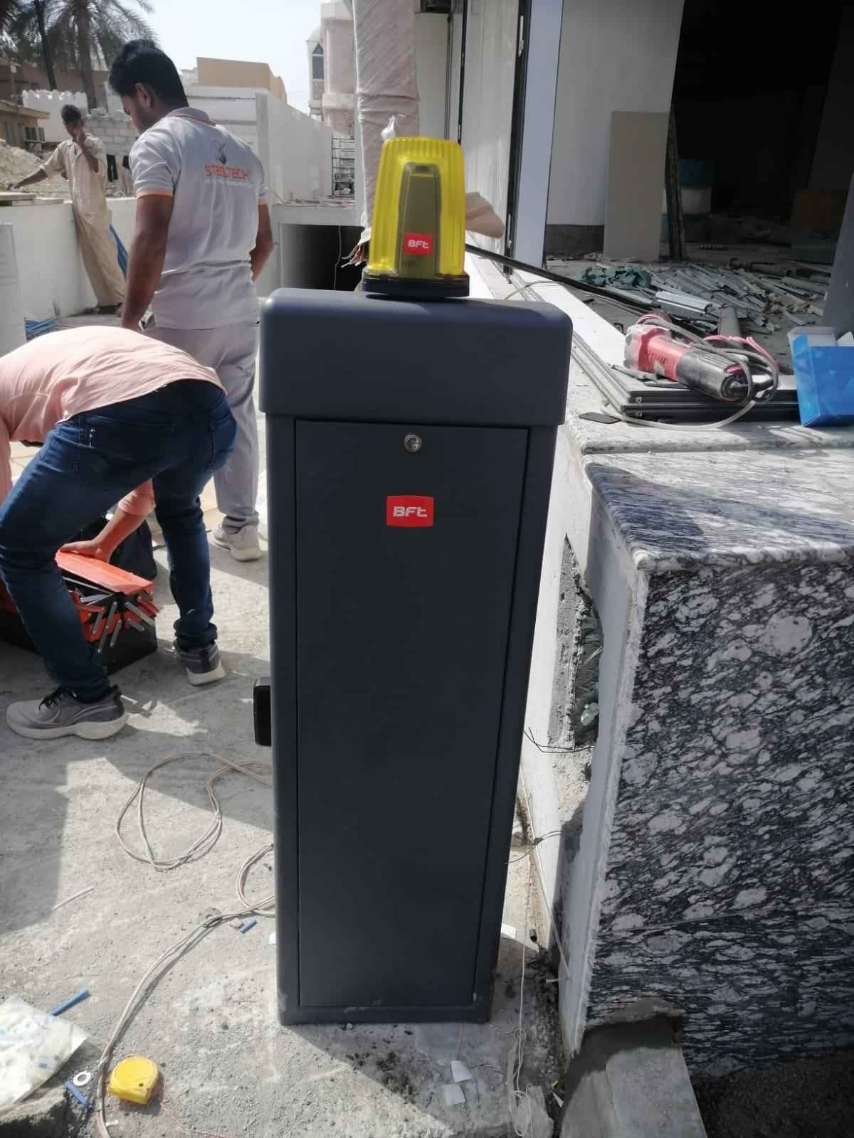 BFT boom barrier cabinet during installation at an entrance in Oman
